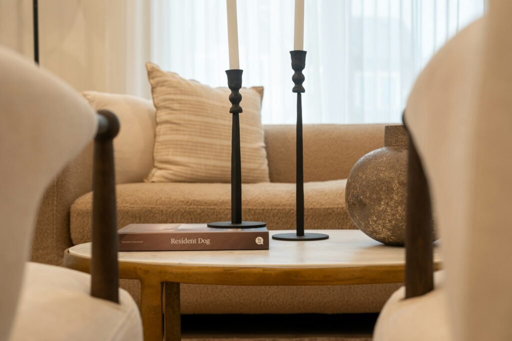 Candlesticks and a book grouped on a coffee table